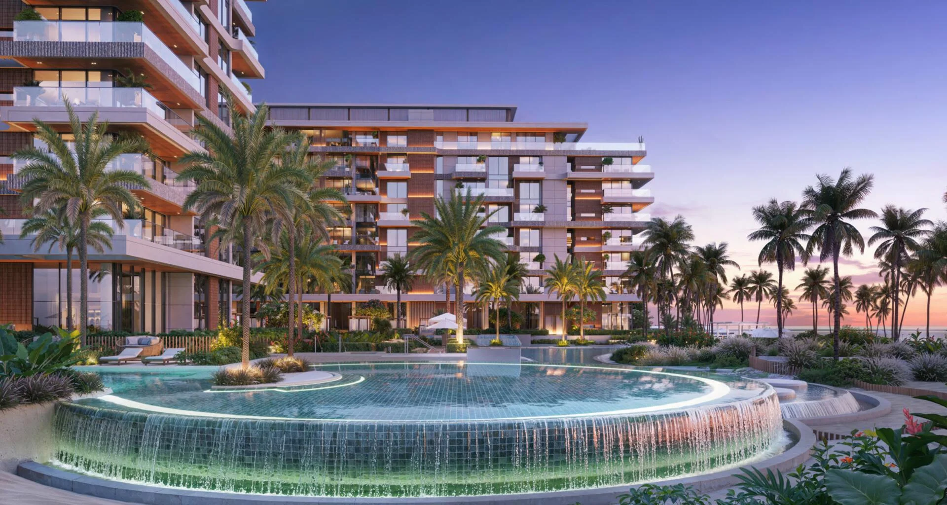 Luxurious beachfront Ellington Cove residences with palm trees, sunset sky, and cascading pool.