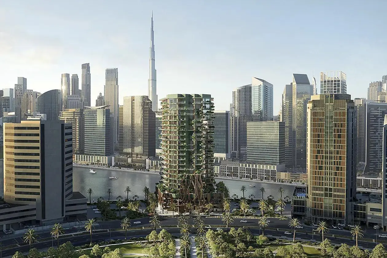 Modern skyline view of Eywa Dubai, a green-clad tower by the waterfront with Burj Khalifa backdrop.