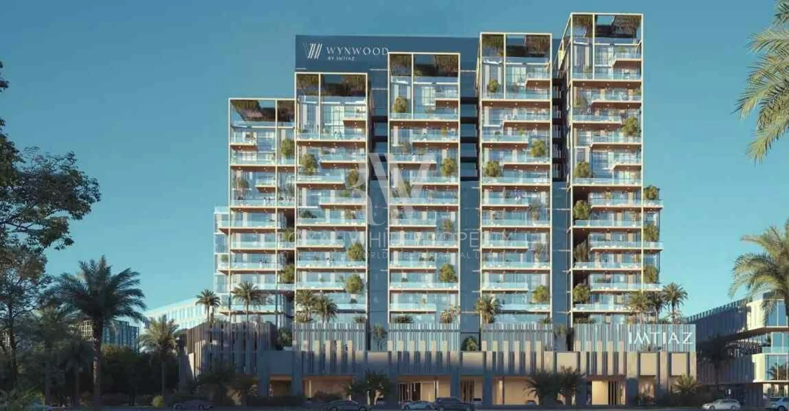 A modern high-rise building with glass balconies, labeled "Imtiaz Wynwood" at the top.