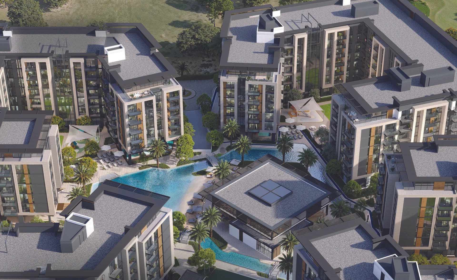 An aerial view of Belgravia Gardens, a modern residential complex with multiple buildings, pools, and palm trees.