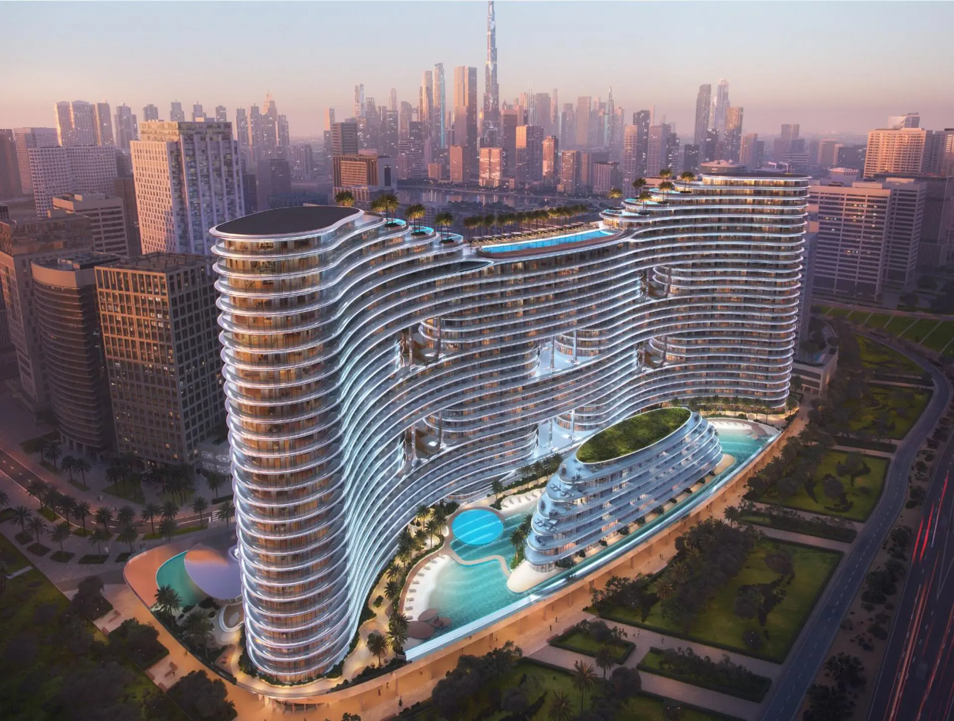 Aerial sunset view of Binghatti Aquarise, a luxury waterfront tower in Business Bay, Dubai.