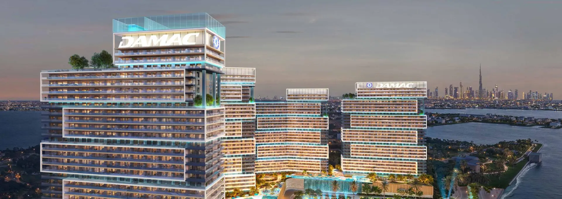 Chelsea Residences towers by DAMAC with skyline views and waterfront at dusk.