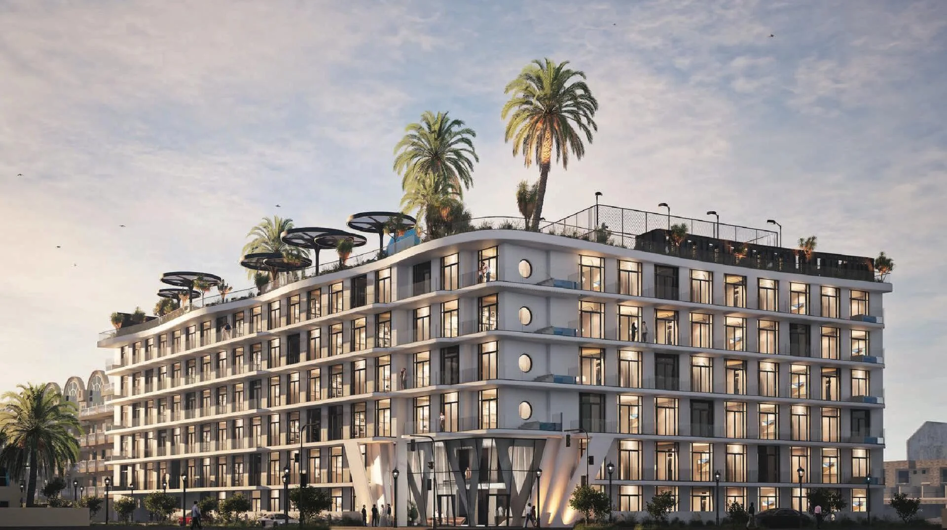 Modern facade of Avana Residences with glass balconies and rooftop greenery