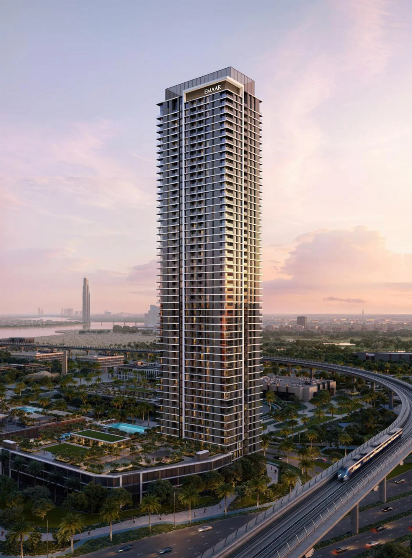 Modern high-rise tower of Montiva by Vida with glass façade overlooking Dubai Creek at sunset