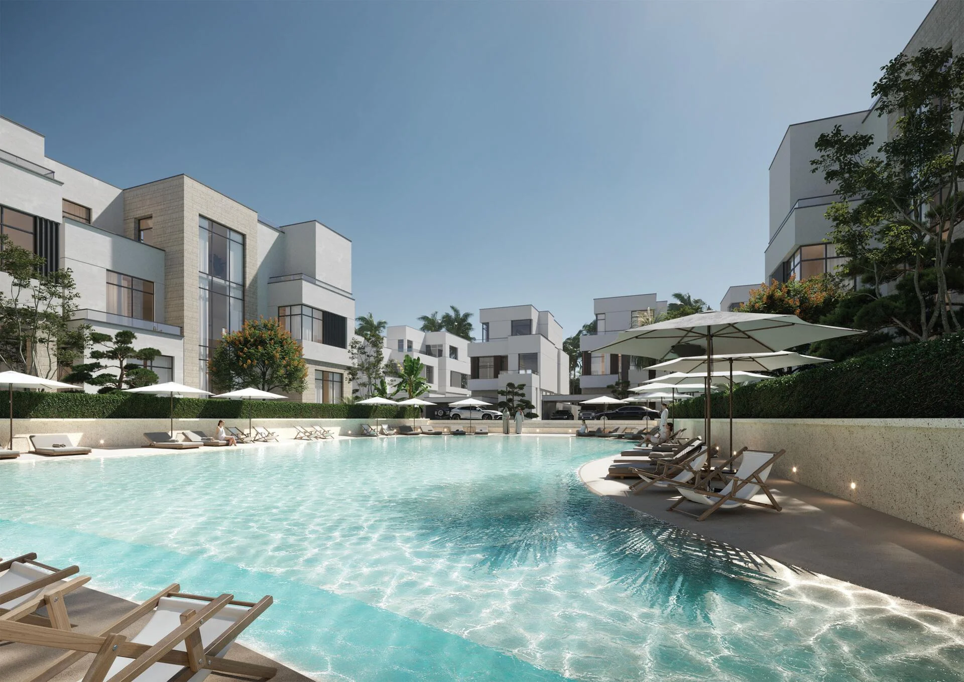 A serene view of the Selora Residences pool, with sunbathers and lounge chairs.