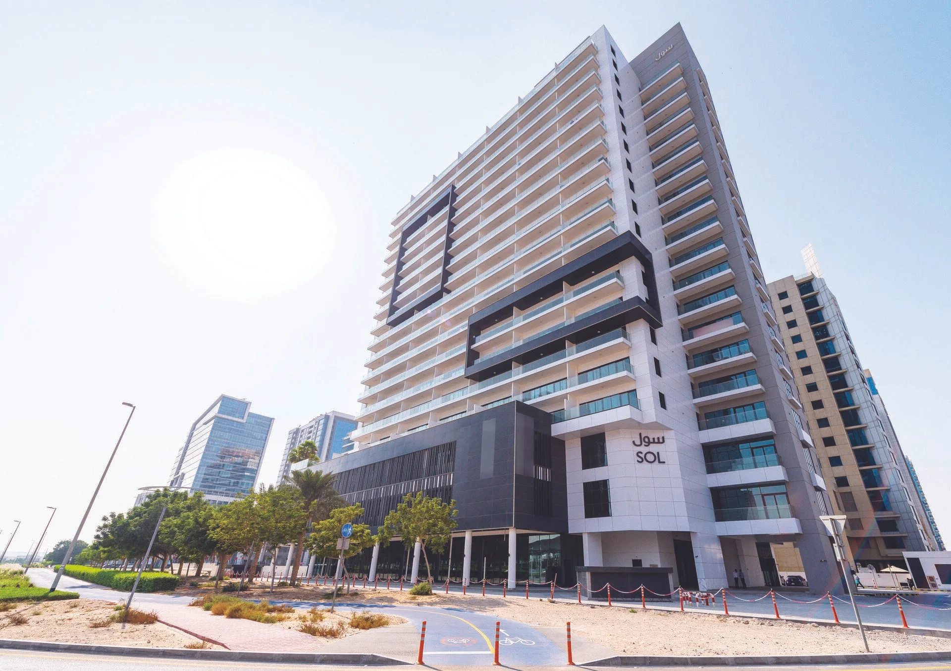 Sol Bay modern high-rise building in Dubai with glass balconies and sleek architectural design.