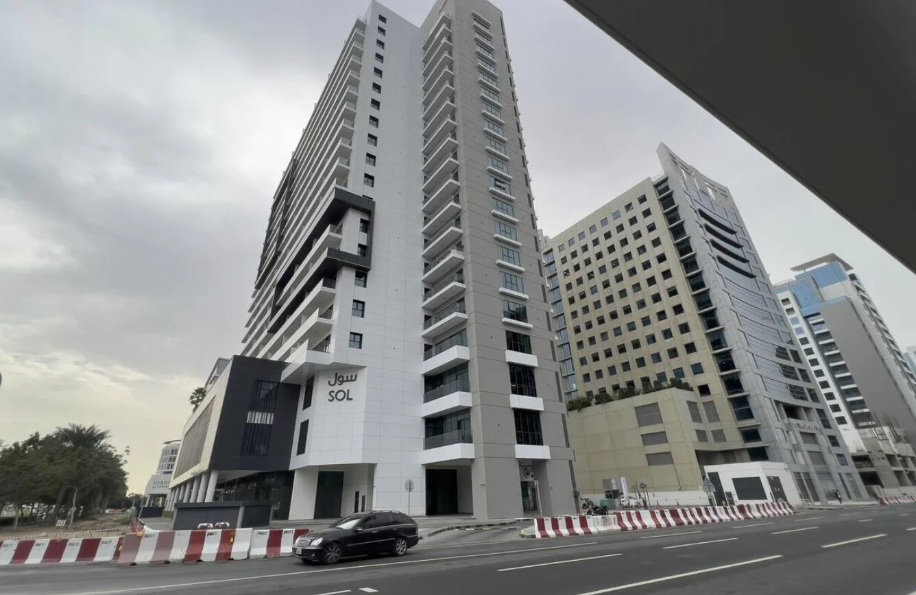 Modern high-rise Sol Bay tower in Business Bay Dubai with glass balconies and urban views.