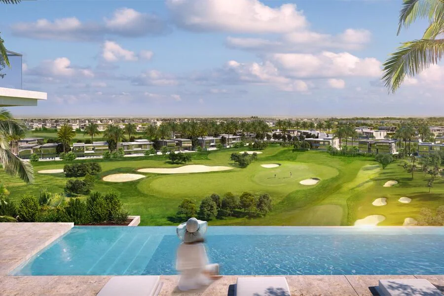 A serene infinity pool overlooks a golf course and nearby Golf Suites Apartments in Dubai.