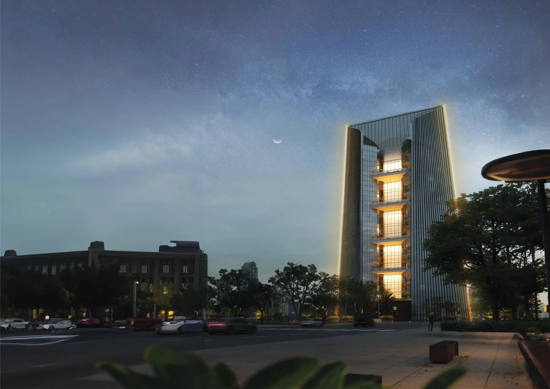 Night view of The One tower with glowing facade and modern architectural design