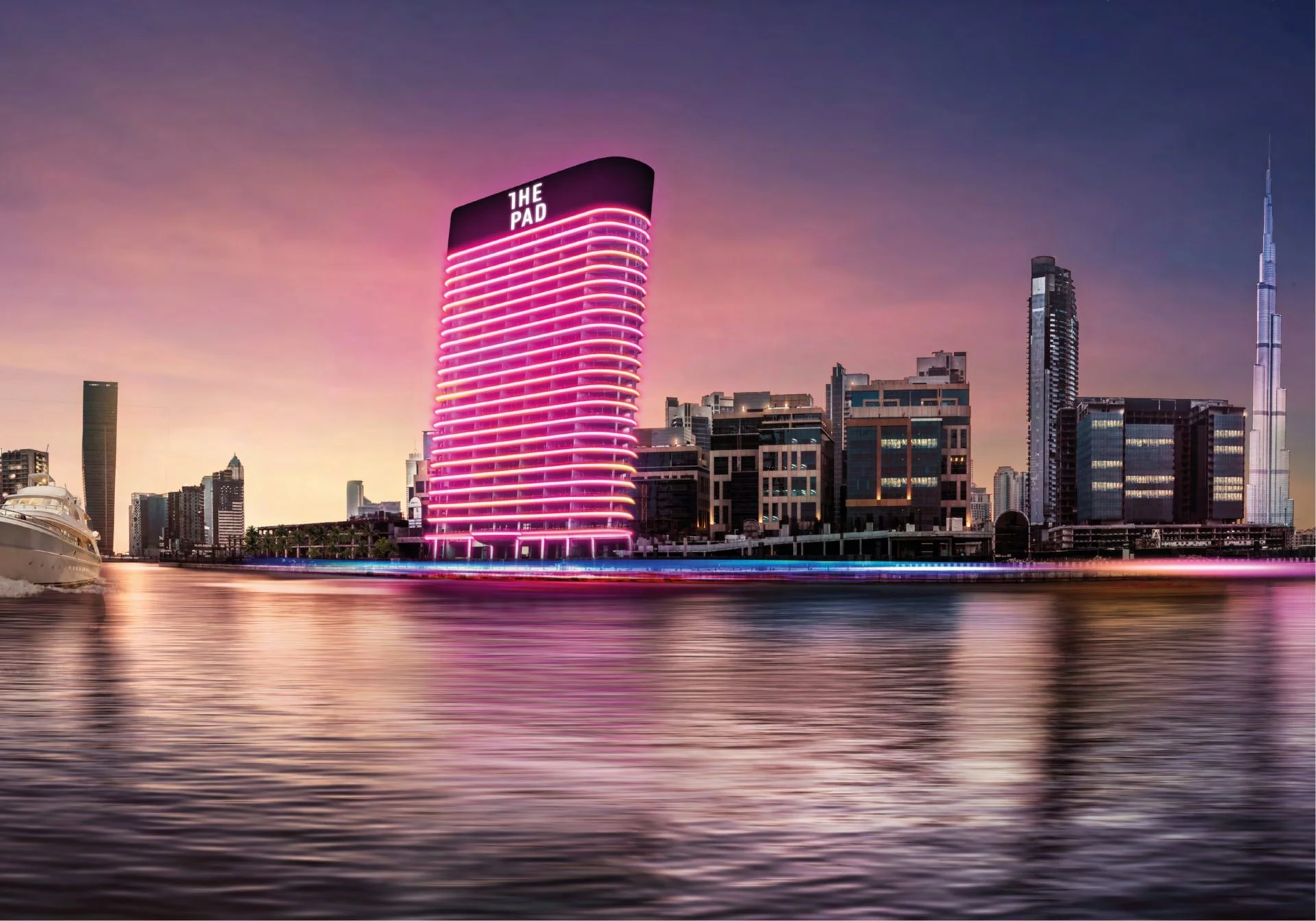 The Pad illuminated tower in Business Bay Dubai with canal and city skyline view